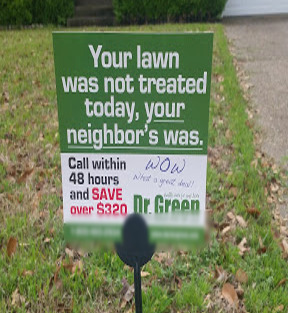 Yard sign with text 'Your lawn was not treated today, your neighbor's was'